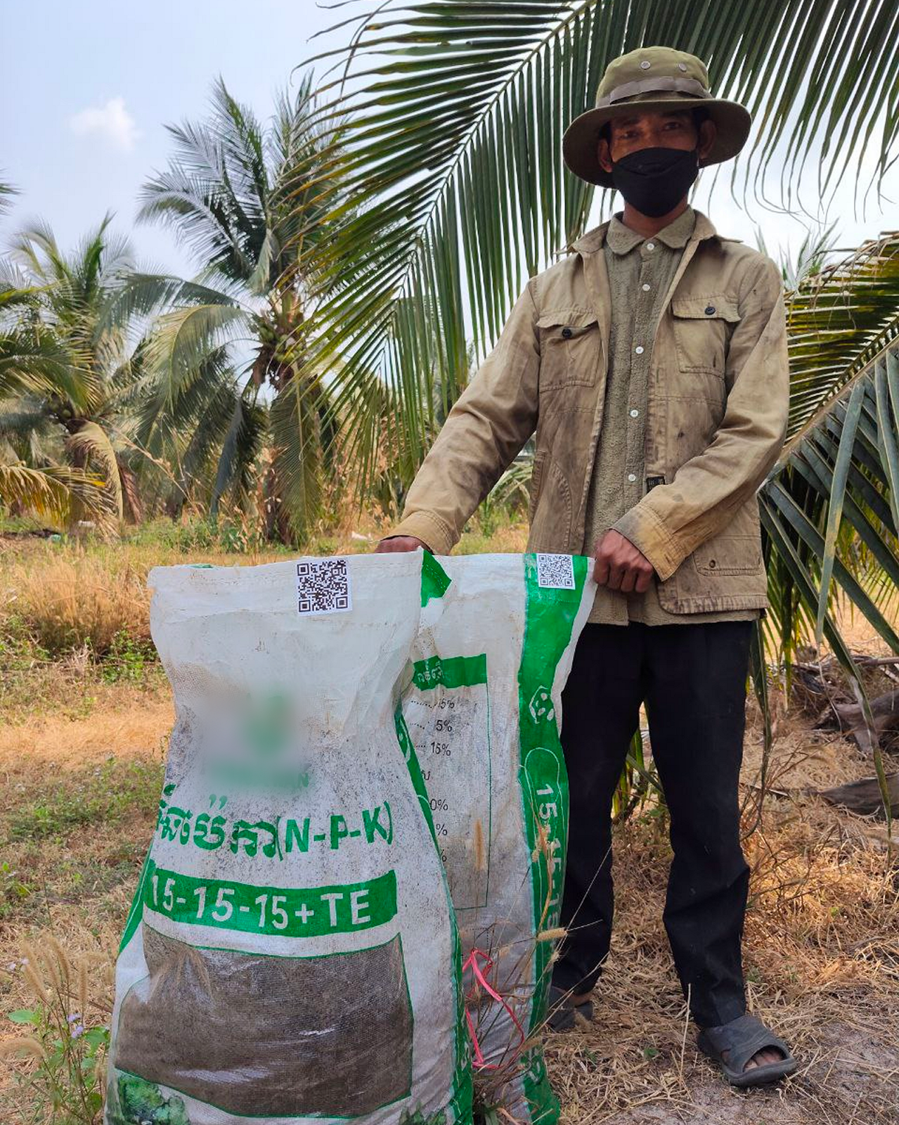 Farmer using fertiliser with a QR code